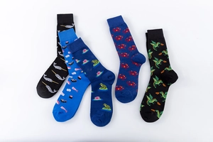 Detail of patterned cotton crew socks featuring narwhal, frog, and dragon illustrations