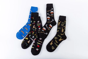 Detail view of five artistic cotton crew socks with diverse themed patterns on white background