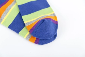 Close-up of rainbow striped cotton socks showing precise toe stitching and knit texture