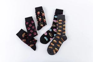 Detail view of cotton socks with various food patterns like popcorn and donuts