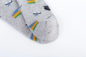 Detail of grey cotton mid-calf socks showing seamless toe stitching and graduation patterns