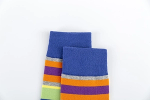 Detail of colorful striped cotton socks showing ribbed elastic cuffs and knit texture