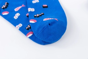 Macro view of blue cotton socks with detailed sushi and dice knit patterns for casual wear