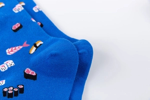 Detail of blue cotton socks featuring cute sushi patterns and reinforced heel stitching