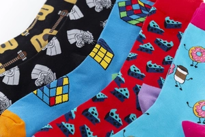 Close-up of vibrant mid-calf cotton socks with guitar, Rubik's cube, and food prints