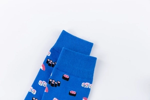 Close-up of blue cotton socks featuring sushi patterns and elastic ribbed cuffs