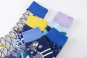 Detail view of colorful Japanese wave and whale patterned cotton mid-calf socks