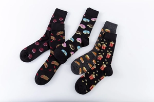 Flat lay view of cotton crew socks featuring various fun food prints like donuts and popcorn