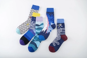 Detailed close-up of artistic cotton socks with blue ocean waves and forest patterns