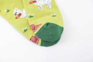 Detail of green knitted sock with alpaca pattern and reinforced dark green toe seam