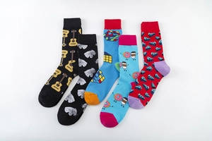 Flat lay showing 5 pairs of colorful cotton mid-calf socks with guitar and donut patterns