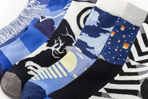 Detailed flat lay of patterned cotton crew socks featuring artistic waves and geometric motifs