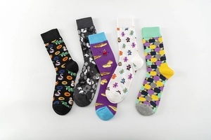 Detailed close-up of 5 pairs of colorful cotton mid-calf socks with playful graphic prints