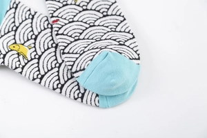 Detailed close-up of ethnic style knit socks featuring wave patterns and fish design