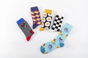 Detailed flat lay of colorful crew socks with fried egg and geometric patterns