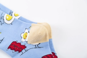Vue macro de chaussettes en coton bleu clair avec motifs œuf au plat et bacon