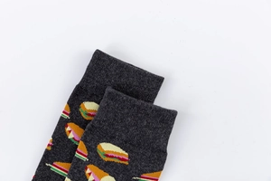 Detail of dark grey crew socks with vibrant cartoon sandwich pattern and ribbed cuffs