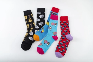 Detailed flat lay of colorful mid-calf socks with guitar, zebra, and cube patterns