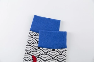 Close-up of knit cotton socks with blue ribbed cuffs and red fish wave patterns