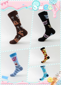 Close-up of colorful cotton crew socks featuring guitar, shark, cat, and pizza patterns