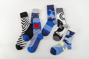 Artistic jacquard crew socks with various landscape patterns including waves and mountains