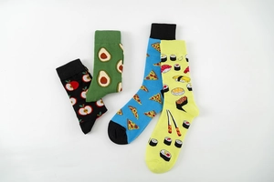 Detailed flat lay of four crew socks featuring apple, avocado, pizza, and sushi patterns