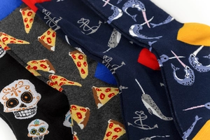 Close-up of cotton mid-calf socks with skull, pizza, and anchor patterns in macro view