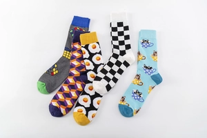 Detailed flat lay of cotton crew socks featuring fried egg, cat, and geometric patterns