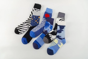 Detail of five pairs of cotton crew socks featuring artistic jacquard patterns and ribbed cuffs