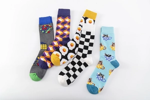 Detailed close-up of five patterned cotton socks including fried egg and checkered designs