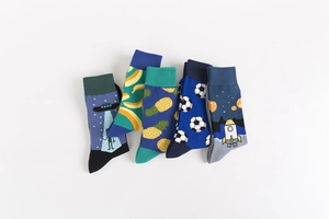 Detailed flat lay of colorful cotton socks with alien, rocket, and pineapple patterns