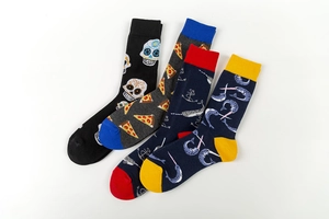 Close-up of four colorful patterned crew socks including sugar skull and pizza motifs