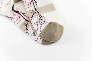 Macro detail of cotton sock toe featuring Japanese style cherry blossom jacquard pattern