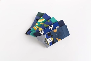 Detail of 5-pack crew socks with space, soccer, and fruit patterns on white background