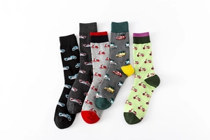 Detail of colorful cotton crew socks featuring retro scooter and car patterns with ribbed cuffs