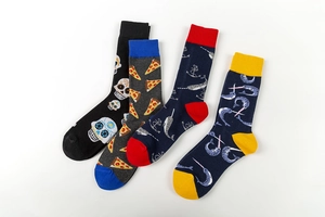 Detail of four colorful mid-calf socks with skull, pizza, and narwhal fun patterns