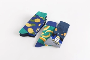 Detail of colorful cotton socks featuring creative pineapple, banana, and rocket patterns