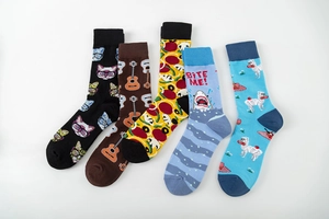 Flat lay of colorful cotton mid-calf socks with guitar, cat, and pizza creative patterns