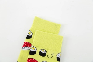 Detail of green and yellow socks featuring salmon sushi print and ribbed cuff design