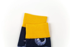 Detail of ribbed elastic cuff on yellow and navy blue cotton mid-tube socks