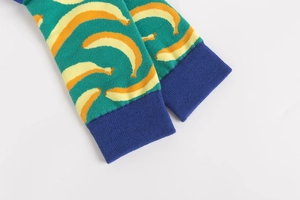 Close-up of green cotton socks with yellow banana pattern and blue ribbed cuffs