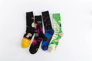 Set of four cotton crew socks featuring cosmic nebulae and geometric patterns