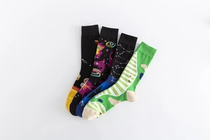 Flat lay of colorful cotton crew socks featuring diverse creative galaxy and golf patterns