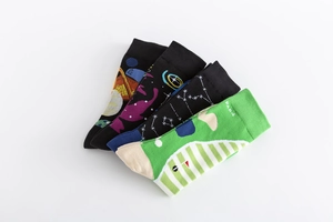 Detailed view of four pairs of colorful cotton socks with space and golf jacquard patterns