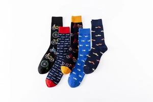 Close-up of five pairs of colorful cotton socks with vintage vehicle patterns and contrast cuffs