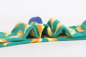 Detailed close-up showing vibrant wavy wave pattern and premium cotton knit texture of socks