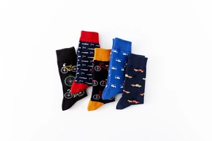 Detailed flat lay of colorful mid-calf cotton socks with fun bicycle and truck patterns