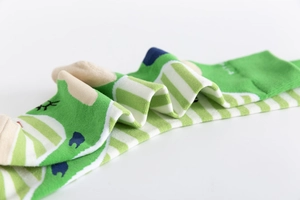 Close-up of green and white striped cotton crew socks with wave pattern details
