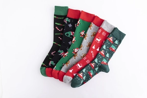 Detailed view of six pairs of Christmas themed cotton socks with reindeer and santa patterns