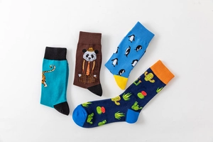 Set of four cotton crew socks featuring vibrant cactus, penguin, panda and tiger patterns